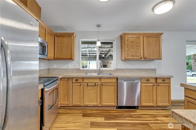 9540 El Camino Ln SE, Yelm, WA 98597 - kitchen featuring stainless steel appliances, light wood-type flooring, light countertops, and pendant lighting
