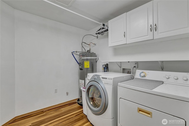 9540 El Camino Ln SE, Yelm, WA 98597 - laundry area with cabinet space, independent washer and dryer, electric water heater, and light wood finished floors