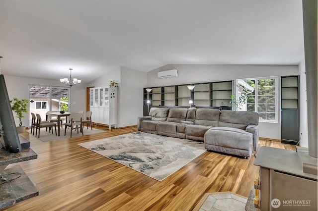 9540 El Camino Ln SE, Yelm, WA 98597 - living room with a wall mounted AC, vaulted ceiling, light wood-type flooring, a chandelier, and healthy amount of natural light