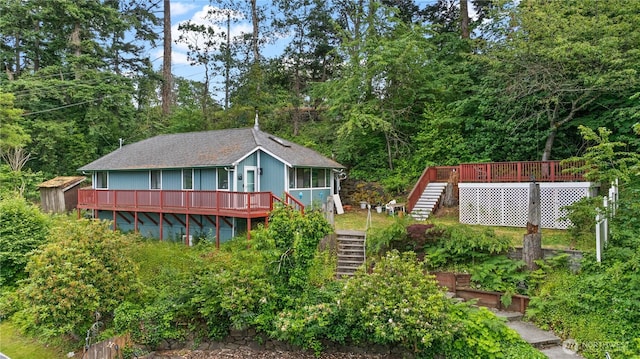 7445S Pine St, Tacoma, WA 98409 - rear view of house with stairs, a deck, and a sunroom