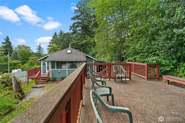 7445S Pine St, Tacoma, WA 98409 - back of house featuring a wooden deck, a sunroom, and roof with shingles