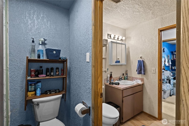 7445S Pine St, Tacoma, WA 98409 - bathroom featuring a textured wall, vanity, wood finished floors, and a textured ceiling
