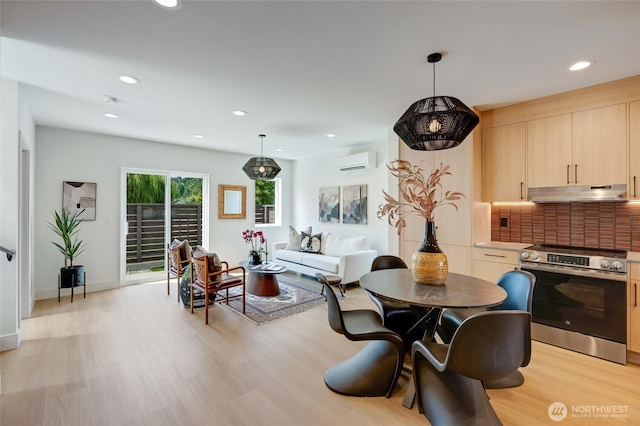 5427 25th Ave SW, Seattle, WA 98106 - dining space featuring a wall unit AC, light wood-type flooring, and recessed lighting