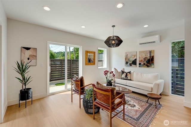5427 25th Ave SW, Seattle, WA 98106 - living room with a wall unit AC, light wood-type flooring, and recessed lighting