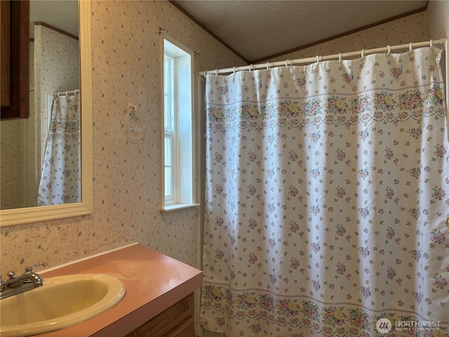 7519 18th Avenue Ct E, Tacoma, WA 98404 - full bathroom featuring wallpapered walls, vanity, ornamental molding, vaulted ceiling, and curtained shower