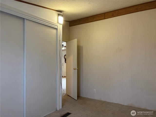 7519 18th Avenue Ct E, Tacoma, WA 98404 - unfurnished bedroom with carpet, a closet, and wood walls