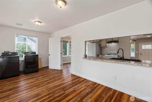 212 Euclid Ave, Shelton, WA 98584 - kitchen with freestanding refrigerator, washing machine and clothes dryer, dark wood-style floors, and under cabinet range hood