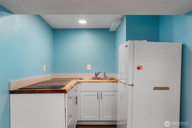 212 Euclid Ave, Shelton, WA 98584 - kitchen with freestanding refrigerator, white cabinets, recessed lighting, and light countertops