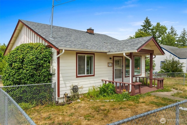 212 Euclid Ave, Shelton, WA 98584 - view of front facade featuring a chimney, roof with shingles, a fenced backyard, and board and batten siding