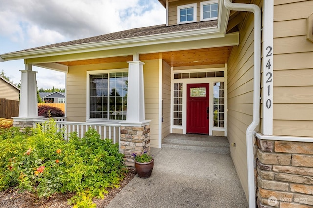 24210 Nookachamp Hills Dr, Mount Vernon, WA 98274 - doorway to property featuring covered porch, stone siding, and a shingled roof