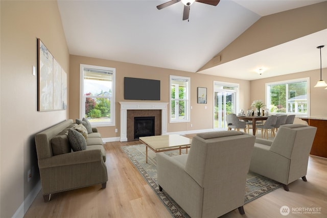 24210 Nookachamp Hills Dr, Mount Vernon, WA 98274 - living area featuring lofted ceiling, light wood-style floors, a fireplace with flush hearth, and ceiling fan