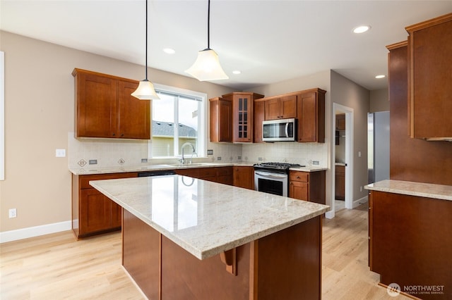 24210 Nookachamp Hills Dr, Mount Vernon, WA 98274 - kitchen featuring stainless steel appliances, light wood-style flooring, recessed lighting, tasteful backsplash, and brown cabinets