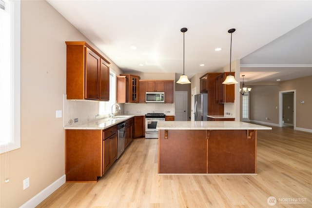 24210 Nookachamp Hills Dr, Mount Vernon, WA 98274 - kitchen with stainless steel appliances, light wood-style floors, backsplash, glass insert cabinets, and light stone counters