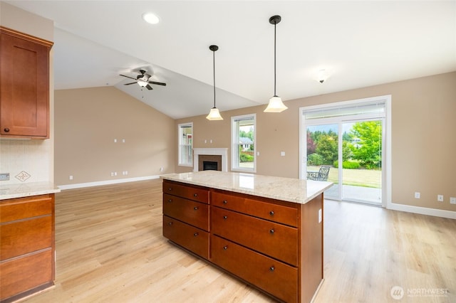 24210 Nookachamp Hills Dr, Mount Vernon, WA 98274 - kitchen featuring ceiling fan, light wood-style floors, open floor plan, a fireplace, and brown cabinetry
