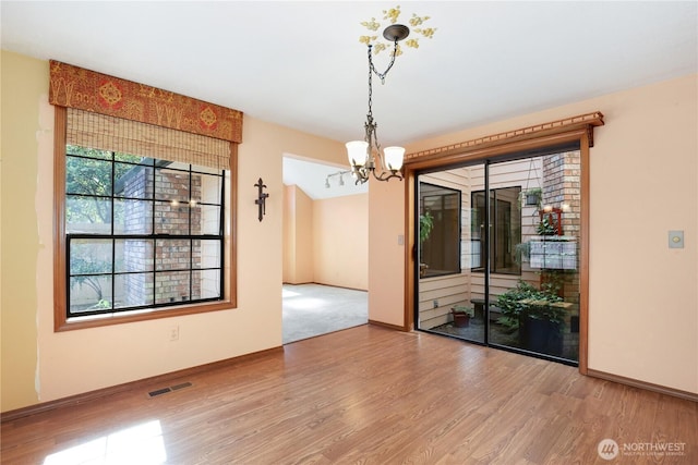 6425 Miner Dr SW, Tumwater, WA 98512 - unfurnished dining area with wood finished floors and a chandelier