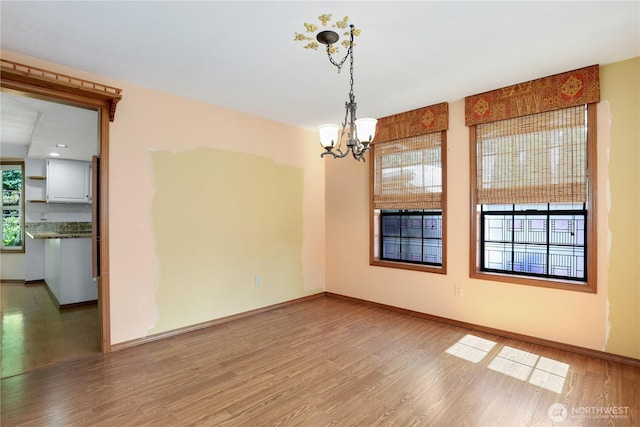 6425 Miner Dr SW, Tumwater, WA 98512 - empty room featuring wood finished floors and a chandelier