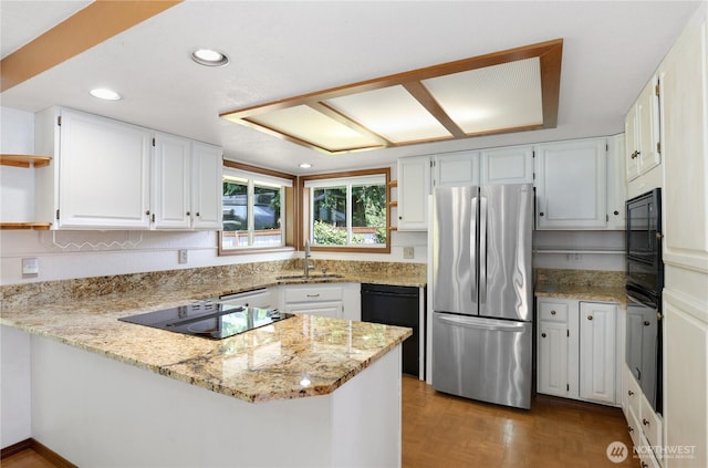 6425 Miner Dr SW, Tumwater, WA 98512 - kitchen featuring black appliances, open shelves, a peninsula, light stone counters, and recessed lighting