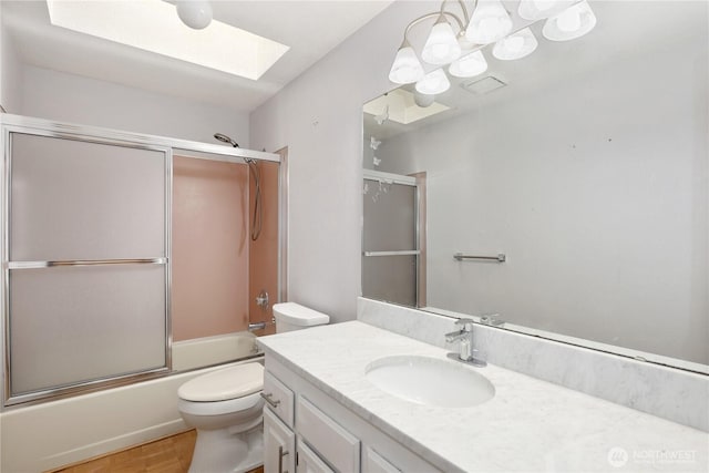 6425 Miner Dr SW, Tumwater, WA 98512 - bathroom featuring a skylight, vanity, enclosed tub / shower combo, and wood finished floors