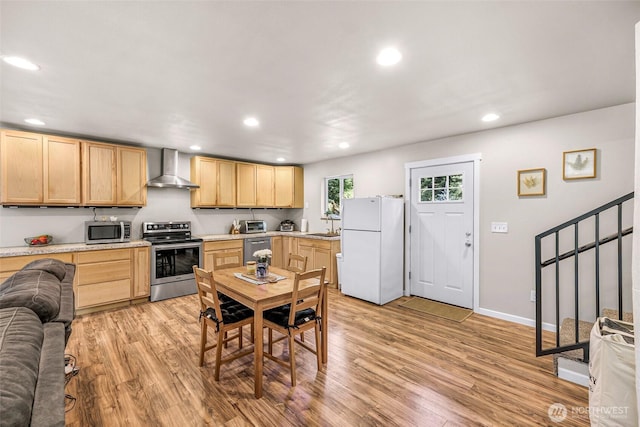2927 Youngs Rd, Custer, WA 98240 - kitchen with stainless steel appliances, wall chimney exhaust hood, light brown cabinets, recessed lighting, and light wood-style floors