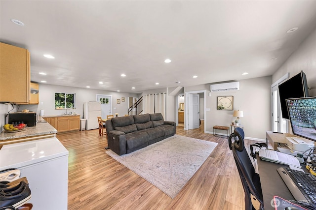 2927 Youngs Rd, Custer, WA 98240 - living area with a wall unit AC, light wood finished floors, stairs, and recessed lighting