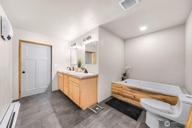 2927 Youngs Rd, Custer, WA 98240 - bathroom featuring double vanity, a garden tub, an AC wall unit, and recessed lighting