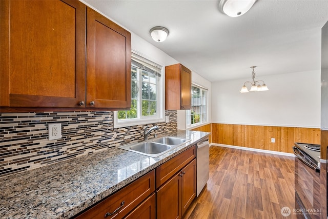12411 134th St E, Puyallup, WA 98374 - kitchen featuring black / electric stove, dishwasher, light wood-style flooring, brown cabinetry, and decorative backsplash
