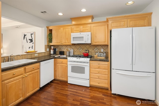 4535 Providence Point Pl SE Unit 202, Issaquah, WA 98029 - kitchen with white appliances, dark countertops, decorative backsplash, dark wood finished floors, and recessed lighting