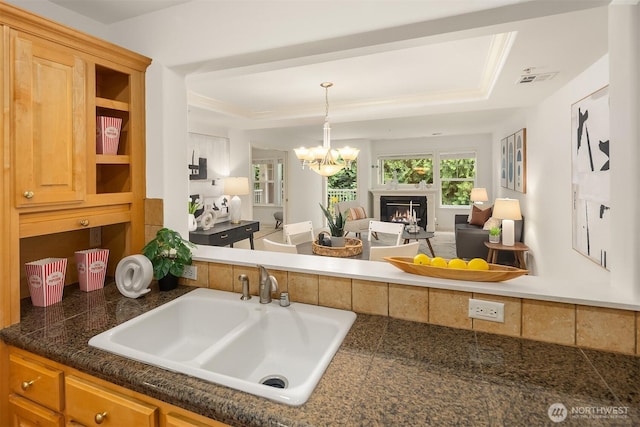 4535 Providence Point Pl SE Unit 202, Issaquah, WA 98029 - kitchen with a raised ceiling, tile countertops, open floor plan, and a chandelier