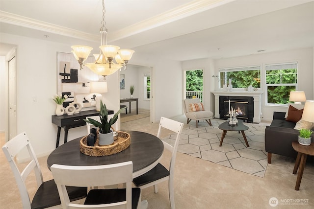 4535 Providence Point Pl SE Unit 202, Issaquah, WA 98029 - dining room featuring a chandelier, light colored carpet, a glass covered fireplace, and ornamental molding