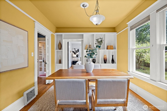 734 N 75th St, Seattle, WA 98103 - dining room featuring healthy amount of natural light and wood finished floors
