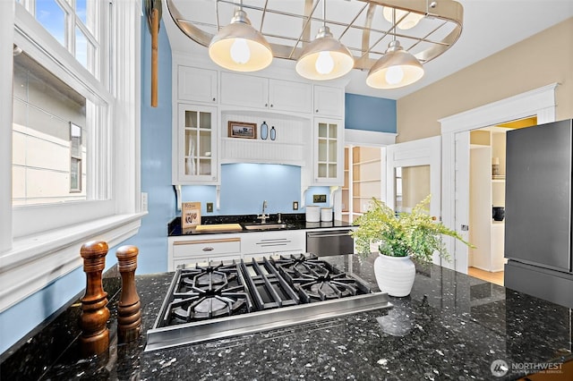 734 N 75th St, Seattle, WA 98103 - kitchen with plenty of natural light, glass insert cabinets, white cabinets, and stainless steel appliances