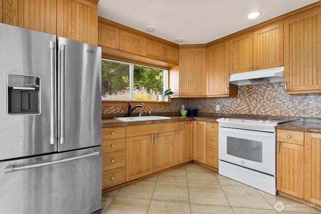 6522 Whitman St NE, Tacoma, WA 98422 - kitchen featuring stainless steel refrigerator with ice dispenser, white electric range oven, under cabinet range hood, dark countertops, and light tile patterned floors