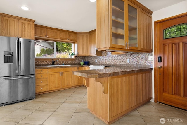 6522 Whitman St NE, Tacoma, WA 98422 - kitchen featuring stainless steel fridge, light tile patterned floors, decorative backsplash, glass insert cabinets, and recessed lighting