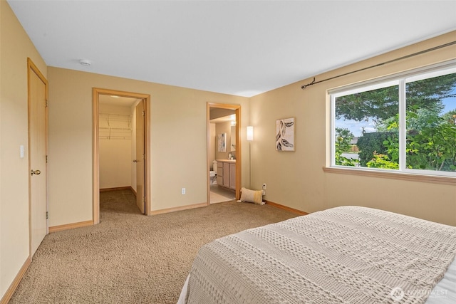 15120 61st St E, Sumner, WA 98390 - bedroom with light colored carpet, a walk in closet, connected bathroom, and a closet