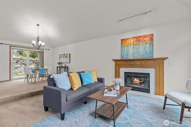 1802 Zephyr Ln NW, Silverdale, WA 98383 - living area featuring a chandelier, rail lighting, vaulted ceiling, carpet, and a tile fireplace