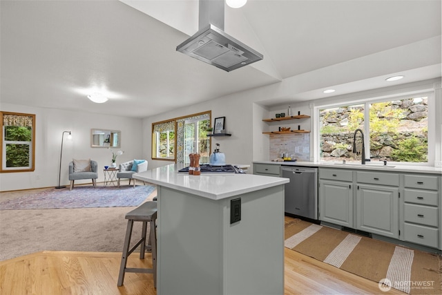 1802 Zephyr Ln NW, Silverdale, WA 98383 - kitchen with stainless steel appliances, wall chimney exhaust hood, a kitchen island, light countertops, and light wood-style floors