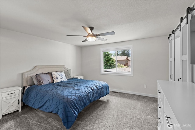 8209 188th Ave E, Bonney Lake, WA 98391 - bedroom featuring a barn door, dark carpet, and ceiling fan