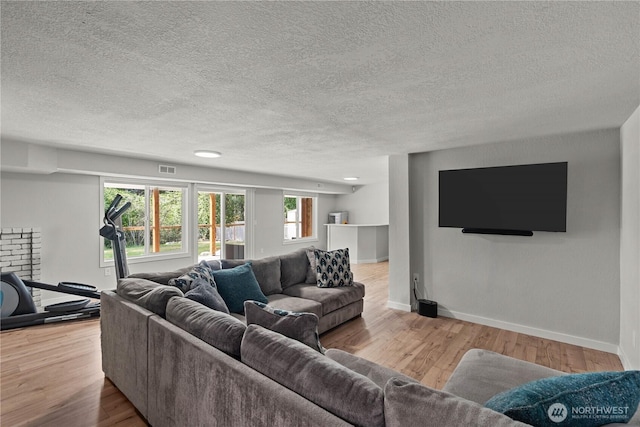 8209 188th Ave E, Bonney Lake, WA 98391 - living area with a textured ceiling and wood finished floors