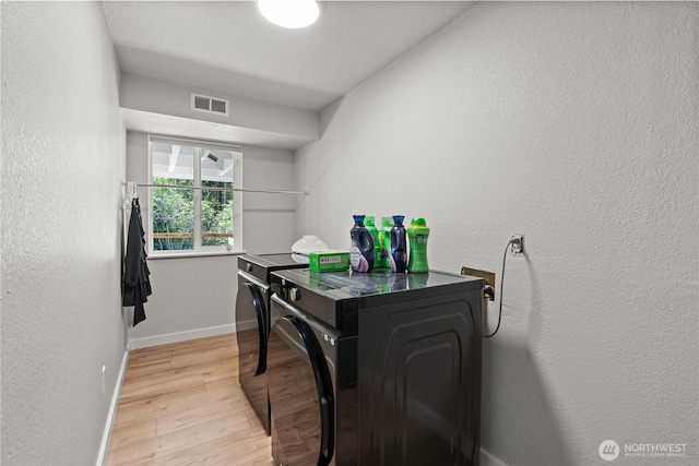 8209 188th Ave E, Bonney Lake, WA 98391 - laundry room featuring washing machine and dryer, light wood-style floors, and a textured wall