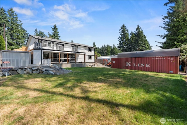 8209 188th Ave E, Bonney Lake, WA 98391 - rear view of house with an outdoor structure, a lawn, and a balcony