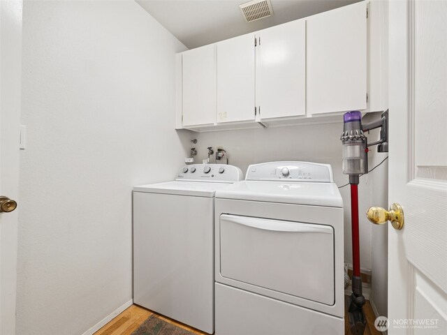 20801 Marine View Dr SW, Normandy Park, WA 98166 - washroom with cabinet space, washer and clothes dryer, and light wood-type flooring