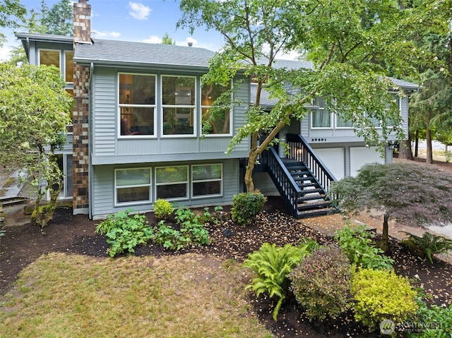 20801 Marine View Dr SW, Normandy Park, WA 98166 - view of front of home with a chimney, stairway, an attached garage, and a shingled roof