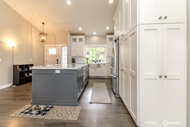 4706 56th St E, Tacoma, WA 98443 - kitchen featuring a center island, white cabinets, dark wood-type flooring, recessed lighting, and decorative light fixtures