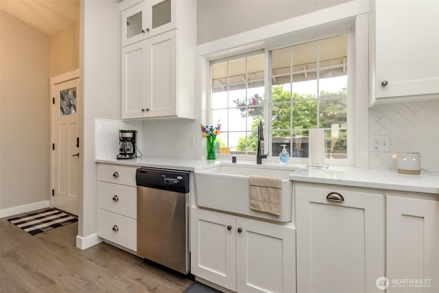 4706 56th St E, Tacoma, WA 98443 - kitchen featuring dishwasher, backsplash, white cabinetry, light wood finished floors, and light countertops