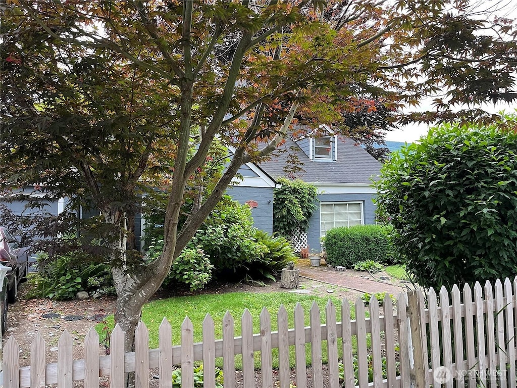 221 E 3rd St, North Bend, WA 98045 - view of property hidden behind natural elements featuring a shingled roof