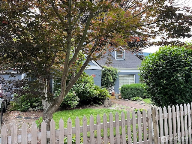 221 E 3rd St, North Bend, WA 98045 - view of property hidden behind natural elements featuring a shingled roof