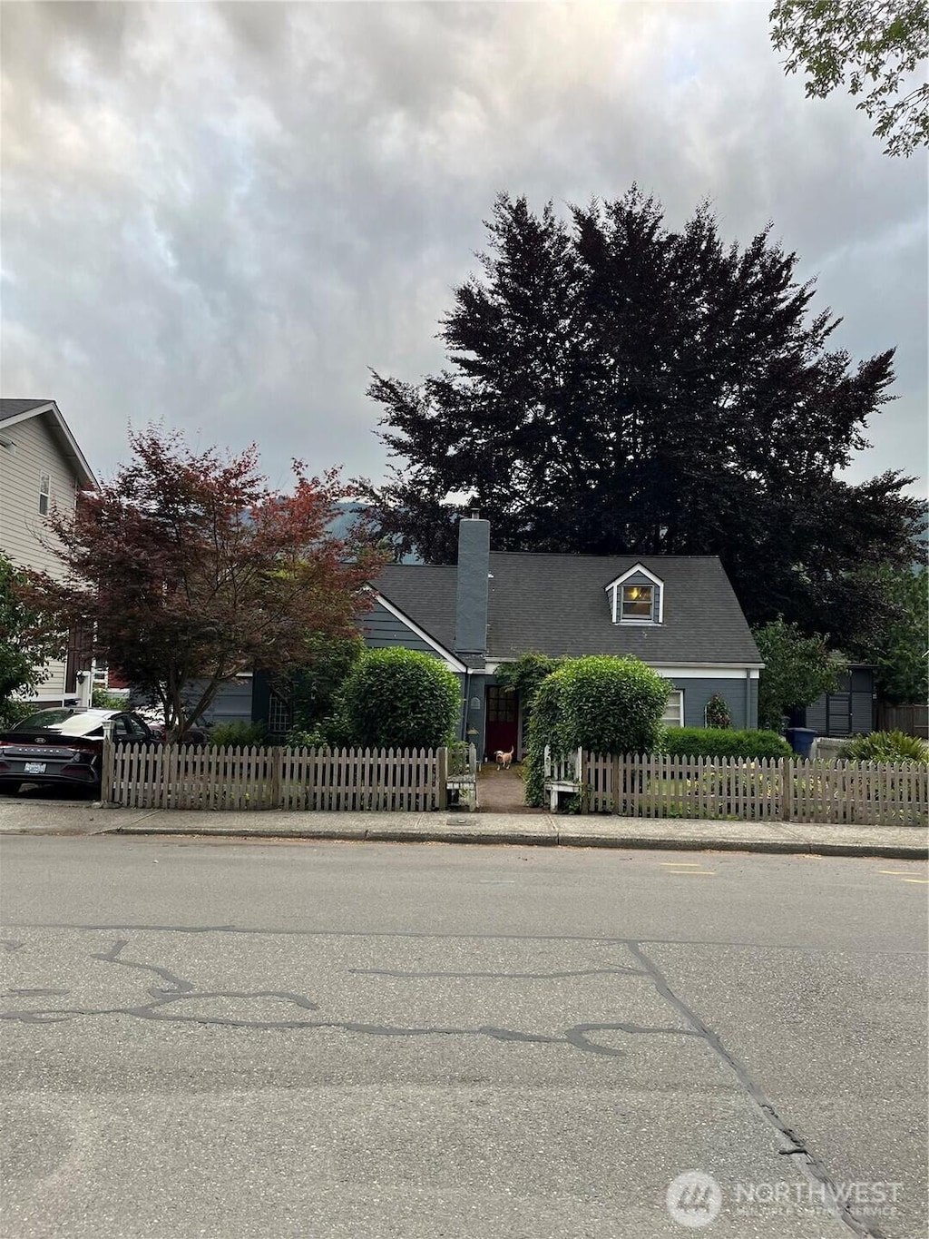 221 E 3rd St, North Bend, WA 98045 - view of property hidden behind natural elements with a chimney
