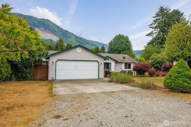 650 Elwell Ave, Darrington, WA 98241 - ranch-style home with a mountain view, gravel driveway, and an attached garage