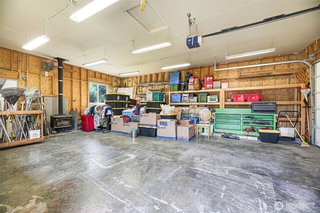 650 Elwell Ave, Darrington, WA 98241 - garage featuring a garage door opener and a wood stove