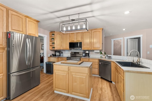 30630 24th Ave S, Roy, WA 98580 - kitchen with stainless steel appliances, a peninsula, light brown cabinetry, light wood-style floors, and light countertops